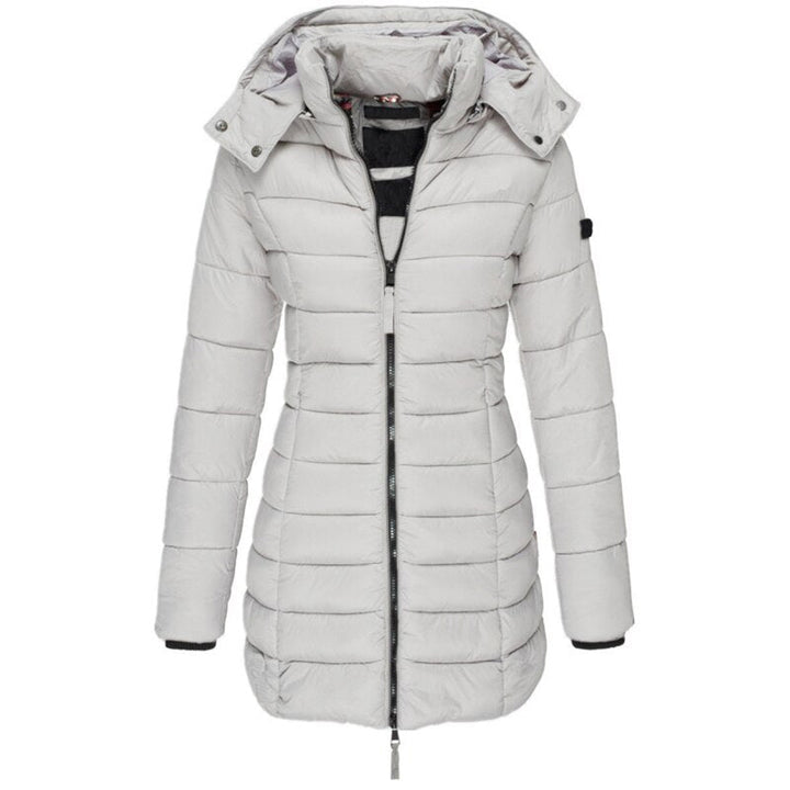 Active woman wearing a stylish hooded winter puffer jacket, enjoying the outdoors. Warm and practical cold weather outerwear.