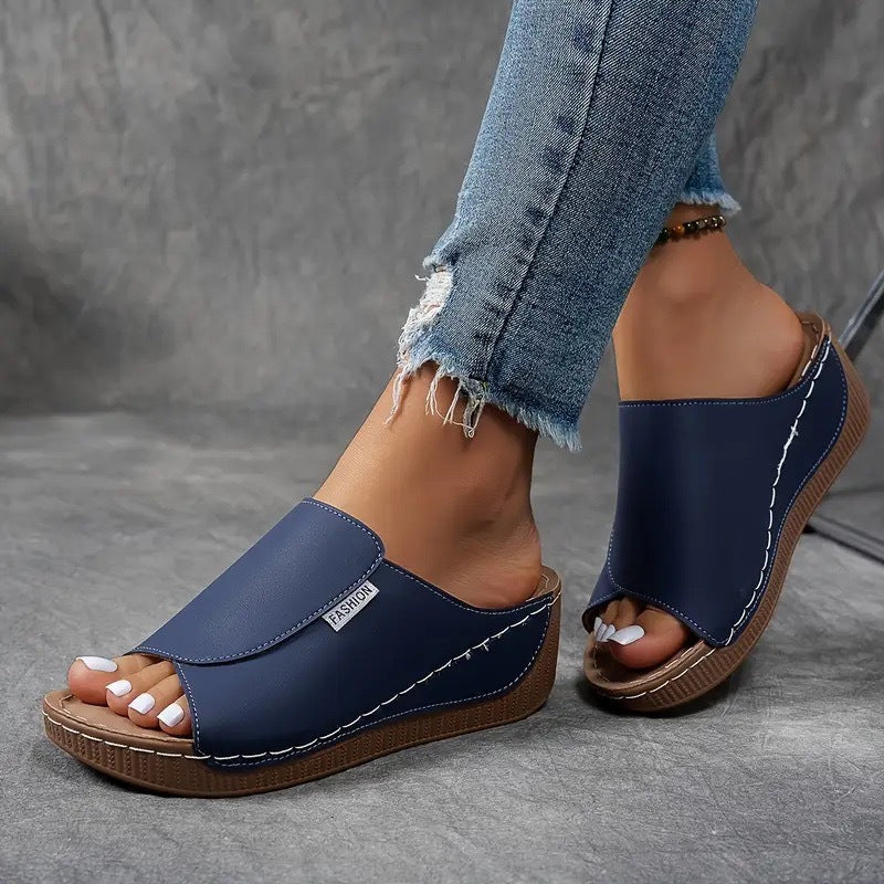 Modern women's open-toe slip-on wedge sandals, blending comfort and style for any summer occasion.