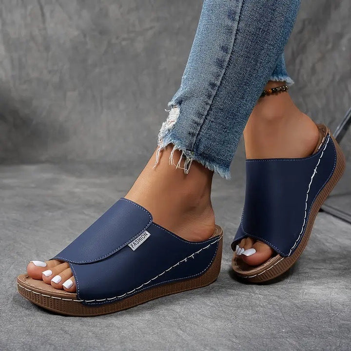 Modern women's open-toe slip-on wedge sandals, blending comfort and style for any summer occasion.
