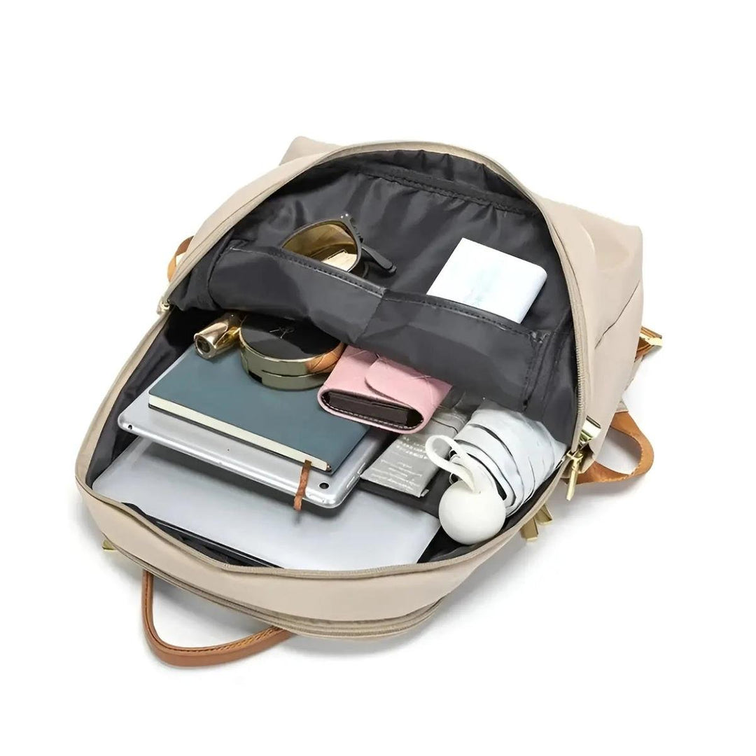 Women's commuter waterproof laptop backpack, sleek design for tech protection.