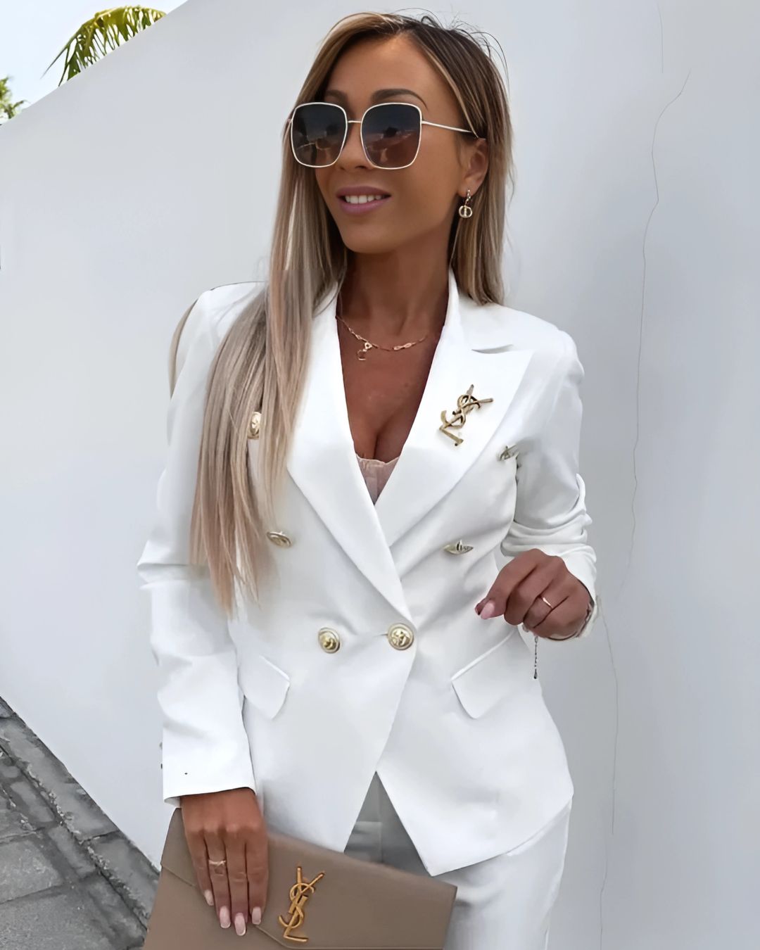 Stylish women's double-breasted suit with metallic buttons and tailored fit; perfect for corporate or formal settings.