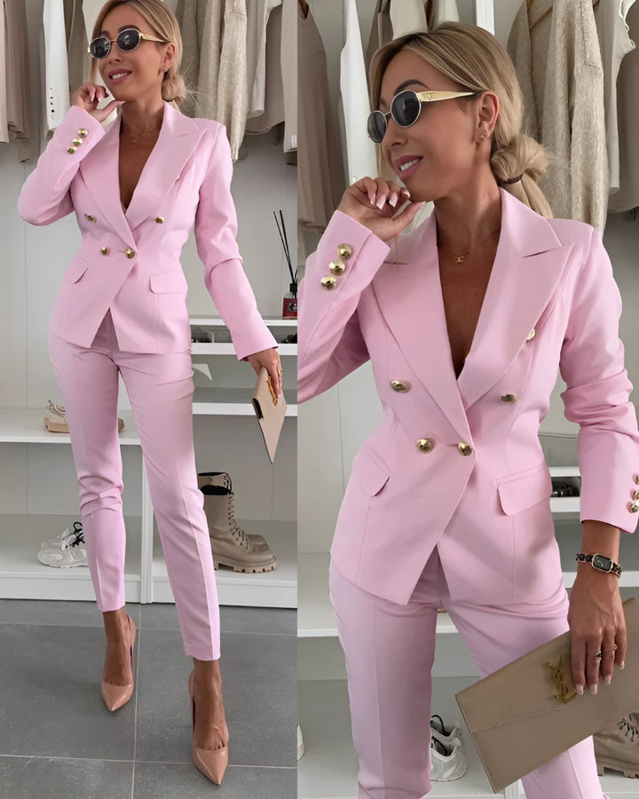 Stylish women's double-breasted suit with metallic buttons and tailored fit; perfect for corporate or formal settings.