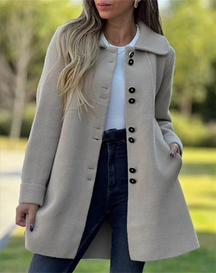 Tailored women's coat with structured silhouette, thigh-length, single-breasted, ideal for business casual wear.