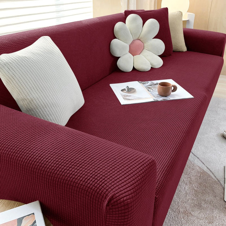 "Textured stretch sofa cover in beige, snug fit for sofas, non-slip, adds elegance, protects against spills and wear."
