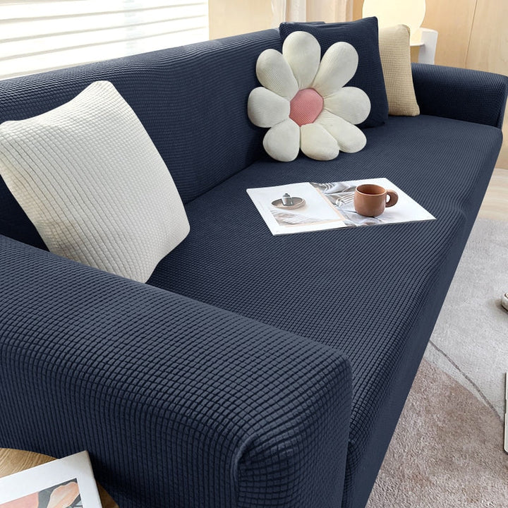 "Textured stretch sofa cover in beige, snug fit for sofas, non-slip, adds elegance, protects against spills and wear."