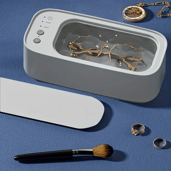 "Ultrasonic cleaning device restoring shine to jewellery, glasses, watches with advanced sound wave technology."