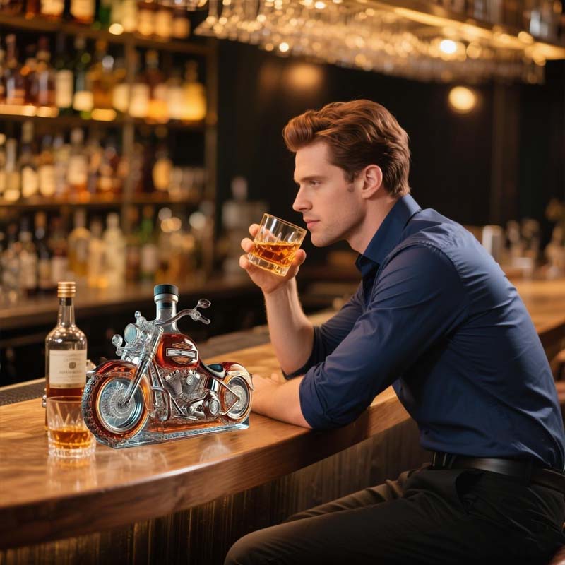 Hand-blown glass motorcycle whiskey decanter, a unique gift for spirits enthusiasts & home bar accessories collection.