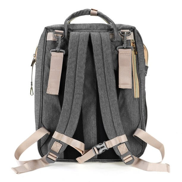 Baby nappy backpack transformed into a secure, comfortable bassinet for a resting infant.