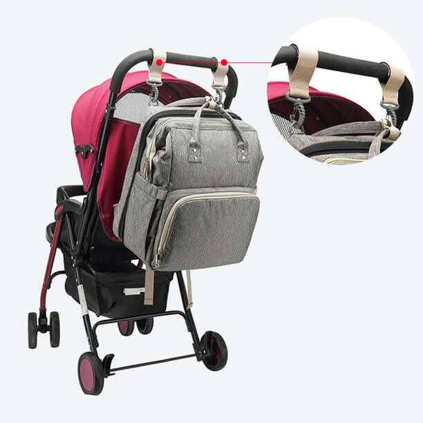 Close-up of the waterproof material and multi-pocket design of the convertible baby travel backpack.