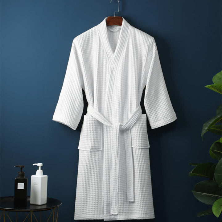 Close-up of soft waffle terry cotton fabric on a unisex bathrobe, great for couples' comfort and spa relaxation.