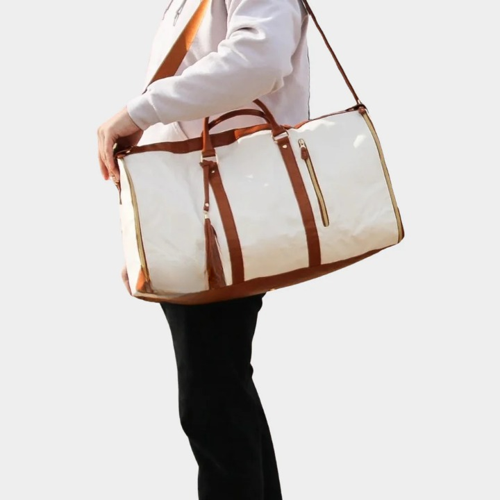Wrinkle-free garment duffel bag for suits. Luxury unisex vegan leather carry-on for organized business travel.