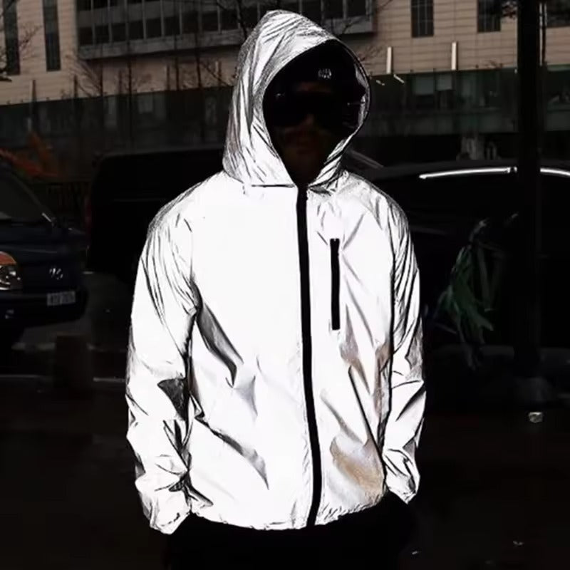 Cyclist in a highly visible reflective waterproof rain jacket, ensuring safety during night rides & rain.