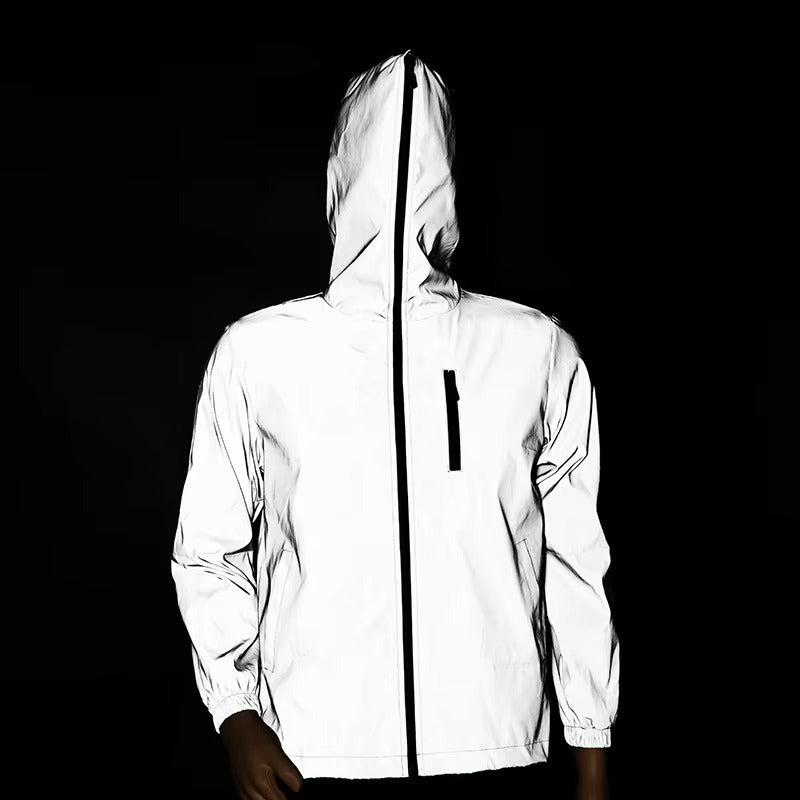 Hiker wearing a unisex reflective waterproof jacket, ideal for outdoor trails, safety, and poor weather.