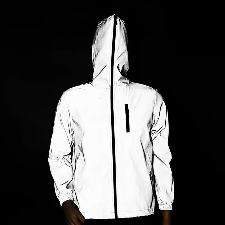 Hiker wearing a unisex reflective waterproof jacket, ideal for outdoor trails, safety, and poor weather.