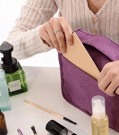 Hanging toiletry bag displayed open in a hotel bathroom, showing easy access to items.
