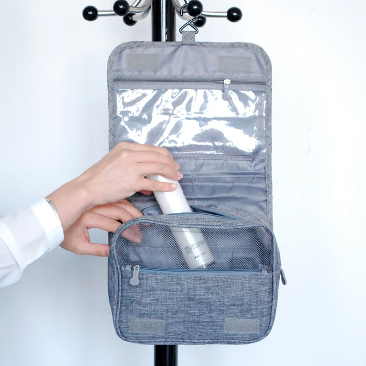 Toiletry organizer folded and packed neatly in luggage, demonstrating compact travel size.