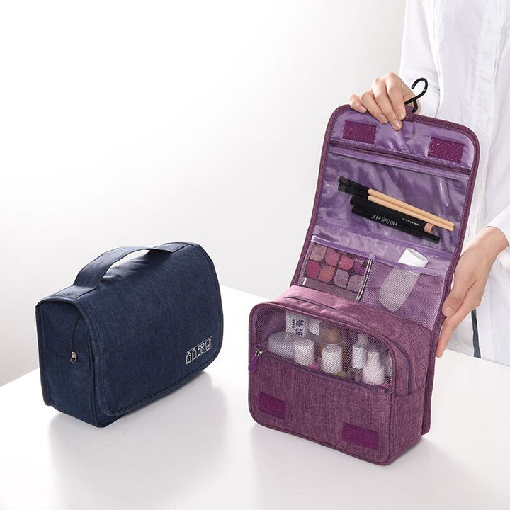 Interior view of hanging toiletry bag showing mesh pockets & zippered compartments for organization.