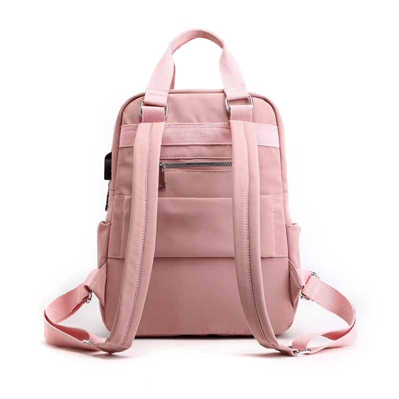 Organized interior of a unisex, multi-compartment anti-theft backpack with USB charging. Ready for travel.