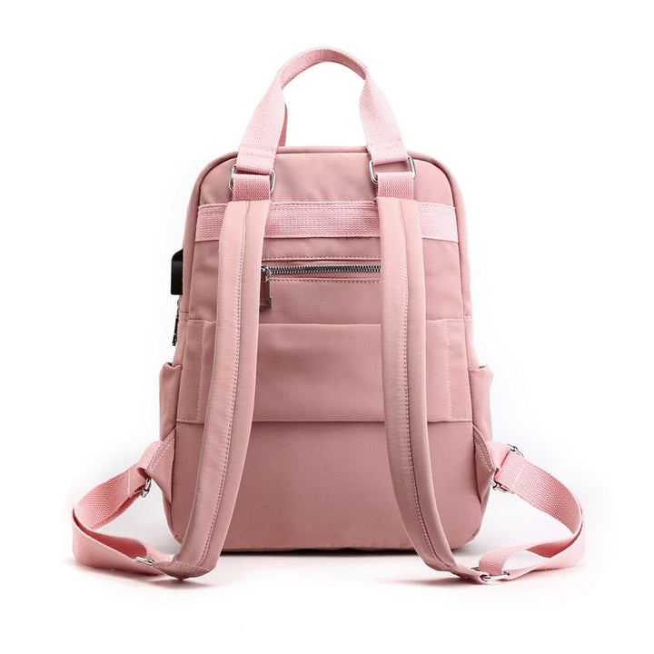 Organized interior of a unisex, multi-compartment anti-theft backpack with USB charging. Ready for travel.