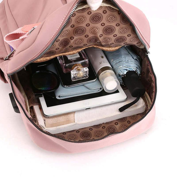 Padded laptop compartment inside a multi-compartment, anti-theft USB charging travel backpack.