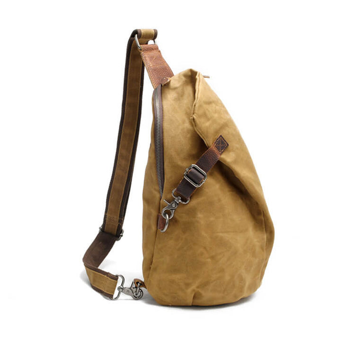 Woman wearing a canvas sling bag with anti-theft pocket, demonstrating secure and compact daily carry.
