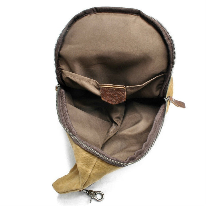 Secure anti-theft pocket detail on a water-resistant canvas crossbody travel bag, back view.