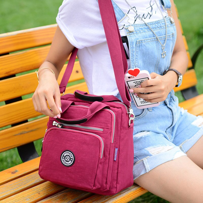 Unisex water-resistant crossbody bag for daily use, featuring multiple pockets for essentials.