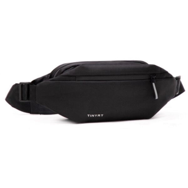 Person wearing a black multi-pocket fanny pack comfortably around their waist, demonstrating hands-free use.