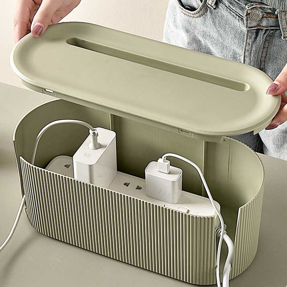 Two universal cable organizers, black, shown managing various tech cables and chargers on a sleek office desk.