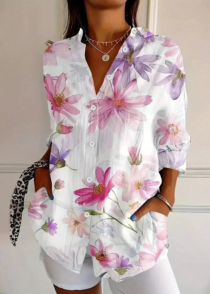 Woman wearing a vibrant printed long sleeve blouse, showcasing its effortless and elegant style.