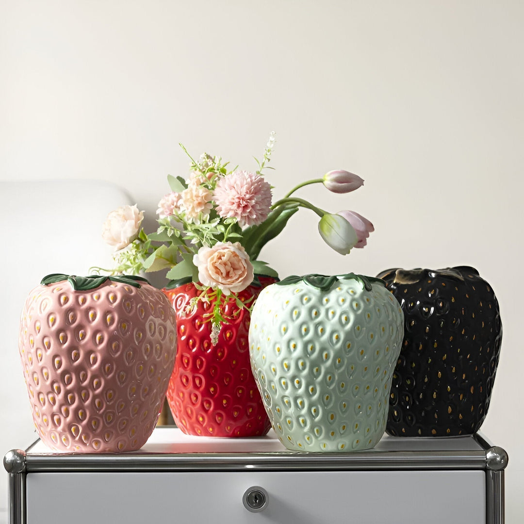 "Vibrant strawberry ceramic vase with whimsical design, perfect for home decor and flower displays, adds playful charm."
