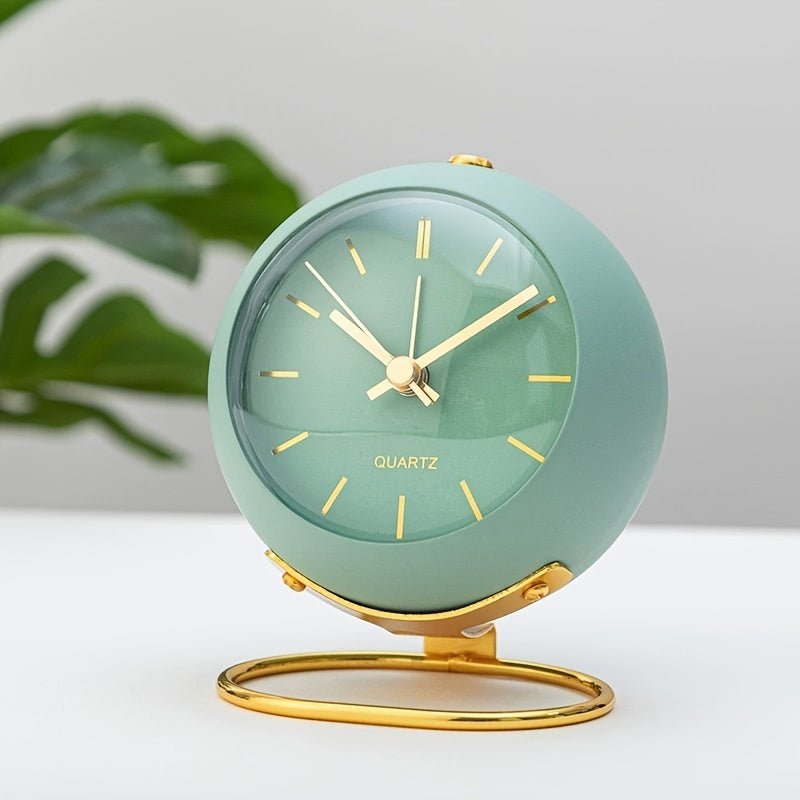 Retro metal analog desk clock with loud classic alarm, a charming vintage bedroom accessory.