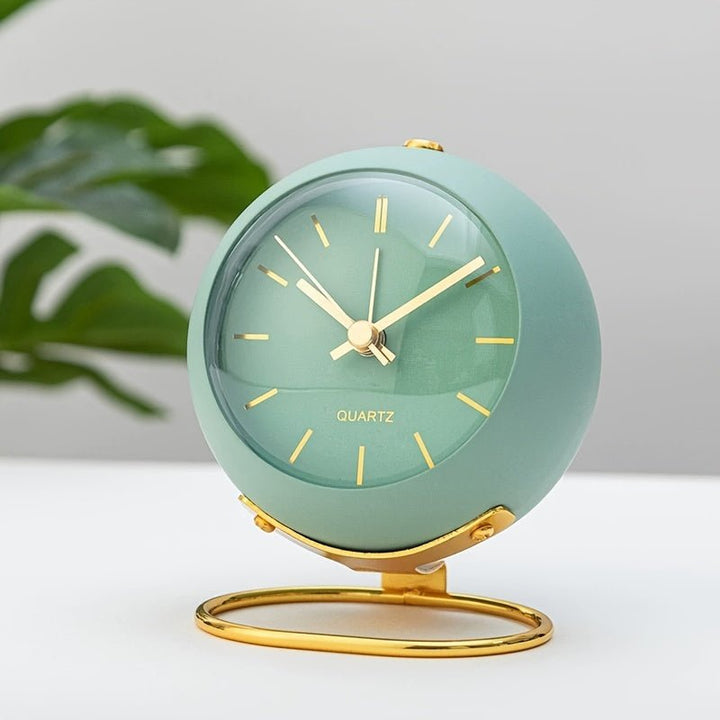 Retro metal analog desk clock with loud classic alarm, a charming vintage bedroom accessory.