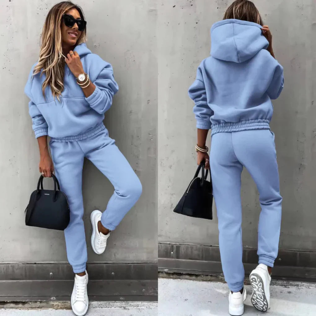 Model wearing a fashionable women's winter tracksuit set, showcasing its flattering fit and sporty design.