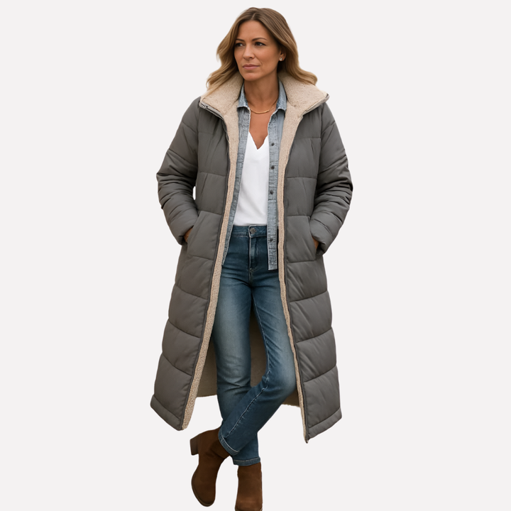Navy women's quilted hooded long coat, offering structured style & warmth. Ideal for fall & winter outerwear.