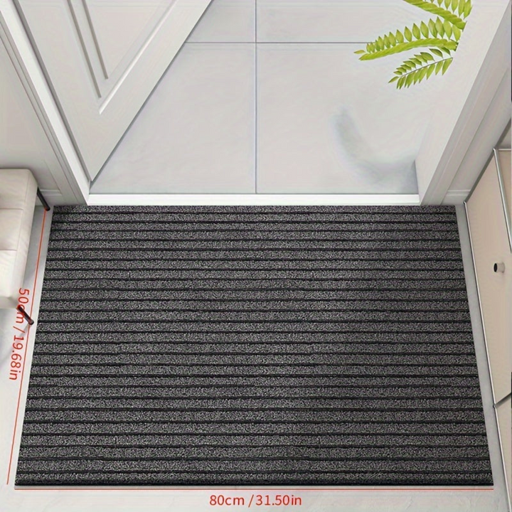 "Weatherproof non-slip outdoor rug with black and grey stripes, ideal for entrances and hallways, enhances safety and style."