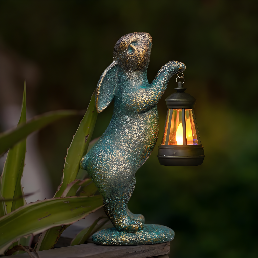 Whimsical bronze rabbit garden statue for outdoor lawn and patio decor. Perfect animal sculpture accent for any garden.