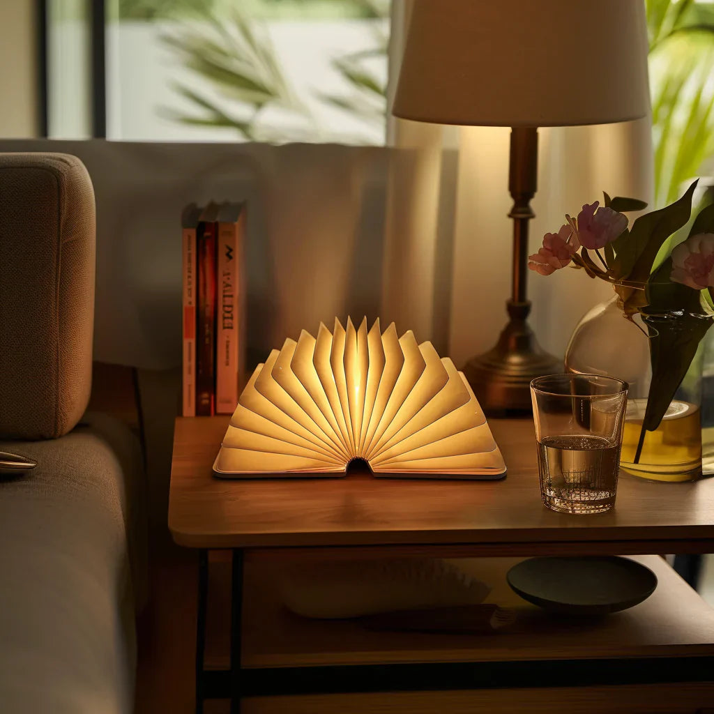 "Whimsical LED book lamp with warm glow, resembling an open book, perfect for cozy decor in bedrooms or study areas."