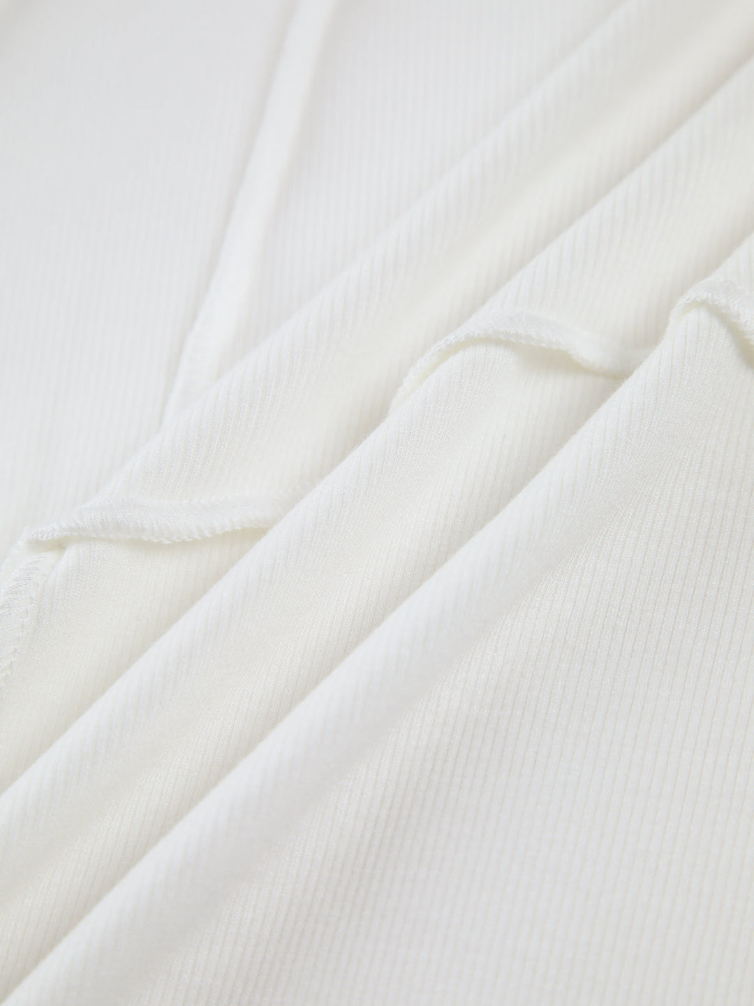 Black ribbed fitted long sleeve top for women. Versatile everyday wear, featuring stylish seam detail.