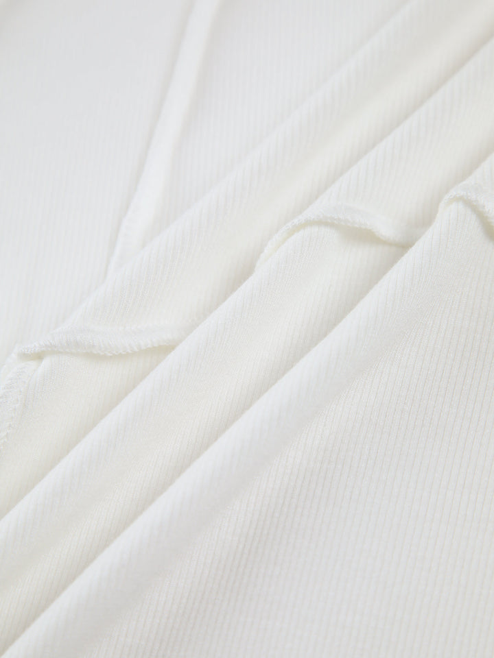 Black ribbed fitted long sleeve top for women. Versatile everyday wear, featuring stylish seam detail.