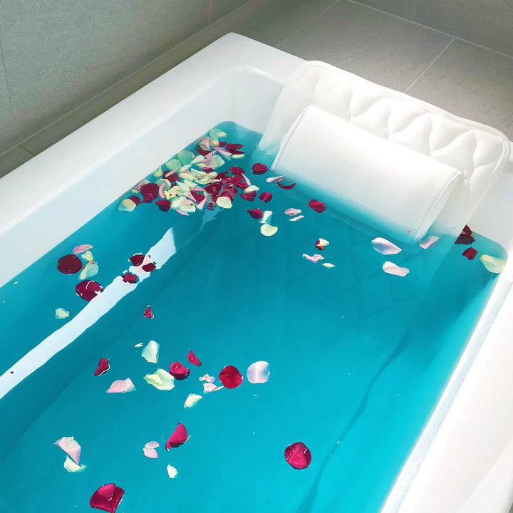 "White full body bathtub pillow with ergonomic design, offering spa comfort and support; made from breathable mesh fabric."