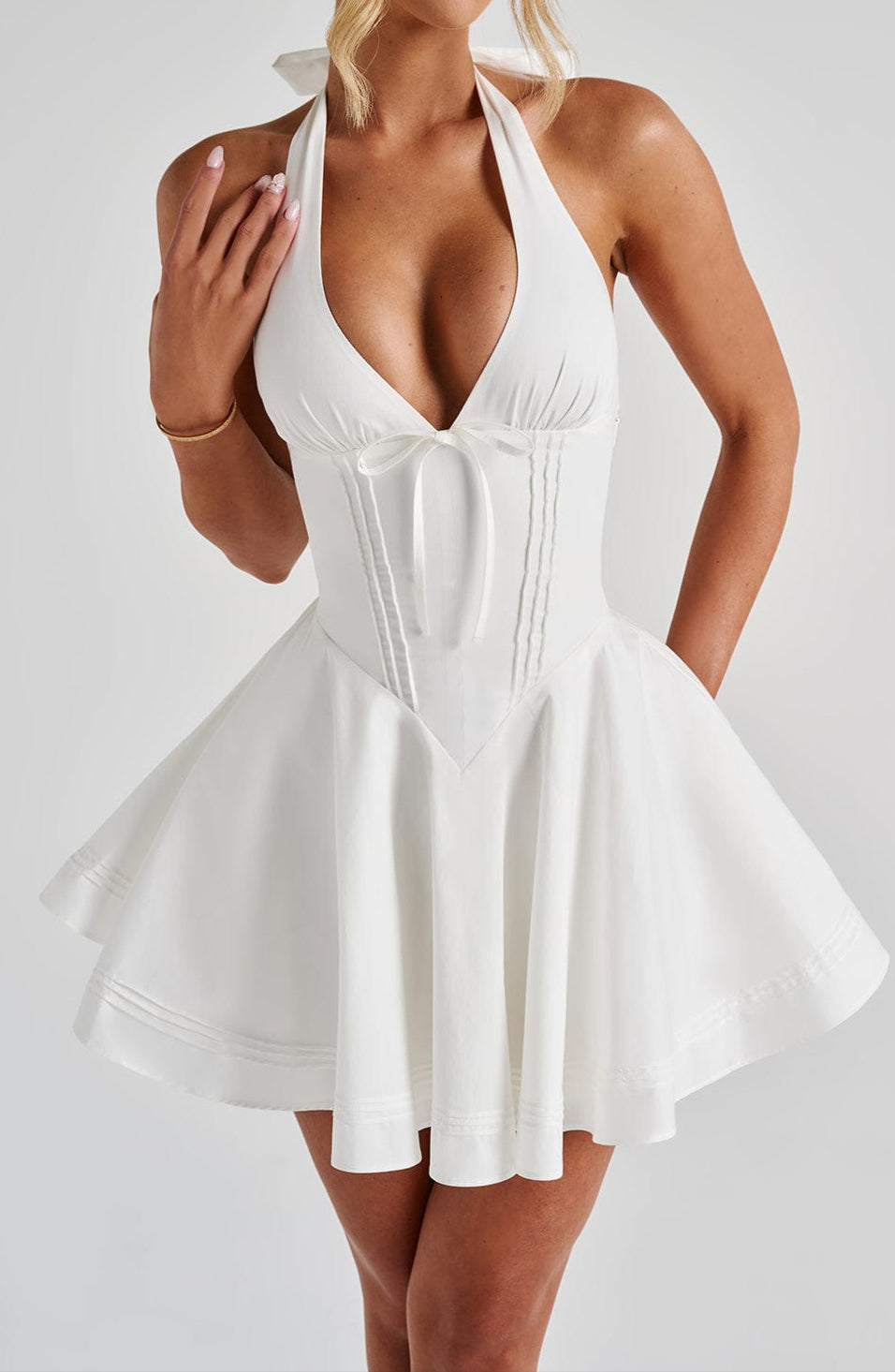 Chic white halter mini dress, a stylish women's fashion choice for parties and cocktails.