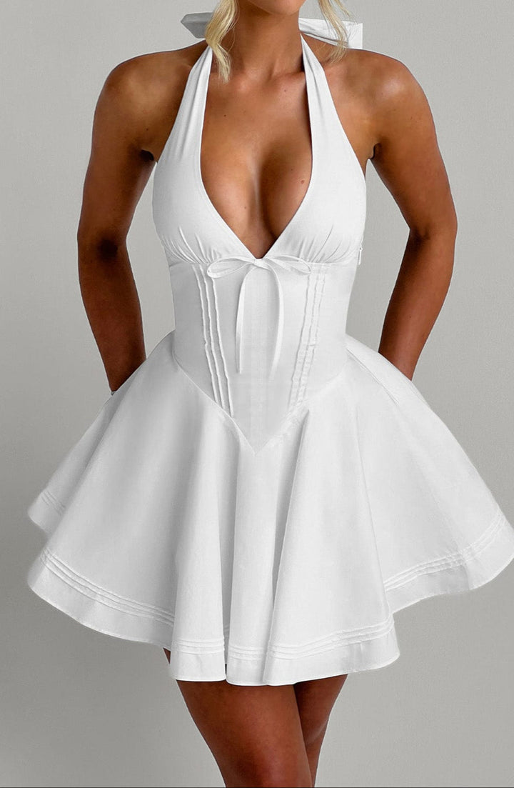 Trendy white halter mini party dress. A versatile sleeveless option for summer evening events.
