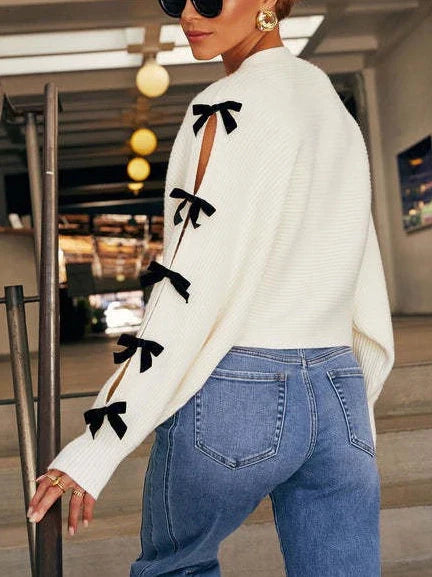 Soft white women's cardigan featuring elegant bow sleeves, ideal for comfortable everyday wear and chic casual layering.
