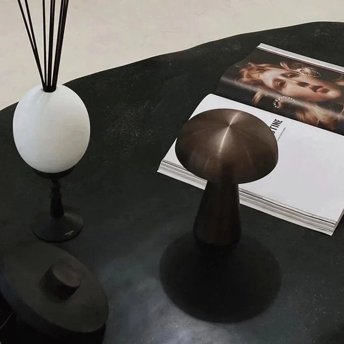 Sleek ShroomLite lamp, wireless & rechargeable, providing warm dimmable ambient lighting.