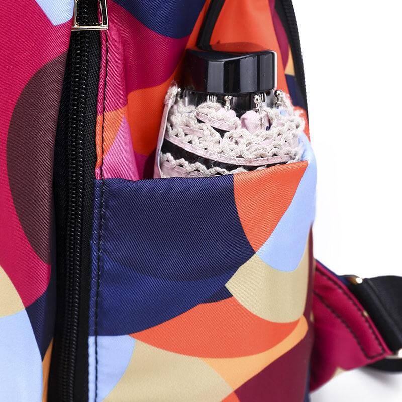 Woman wearing a stylish anti-theft water-resistant backpack, ideal for urban travel & daily tasks.