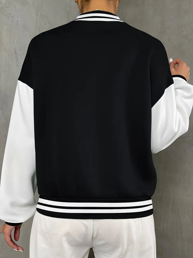 Stylish black & white women's varsity jacket. A trendy collegiate-style outerwear piece for sporty casual looks.