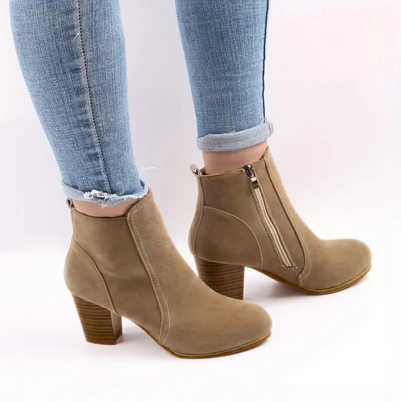 Women's black block heel ankle boots with side zip closure for versatile everyday style.