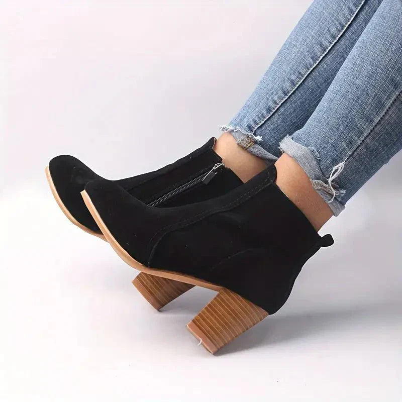 Elegant women's ankle boots with a sophisticated block heel and a functional side zip for easy wear.