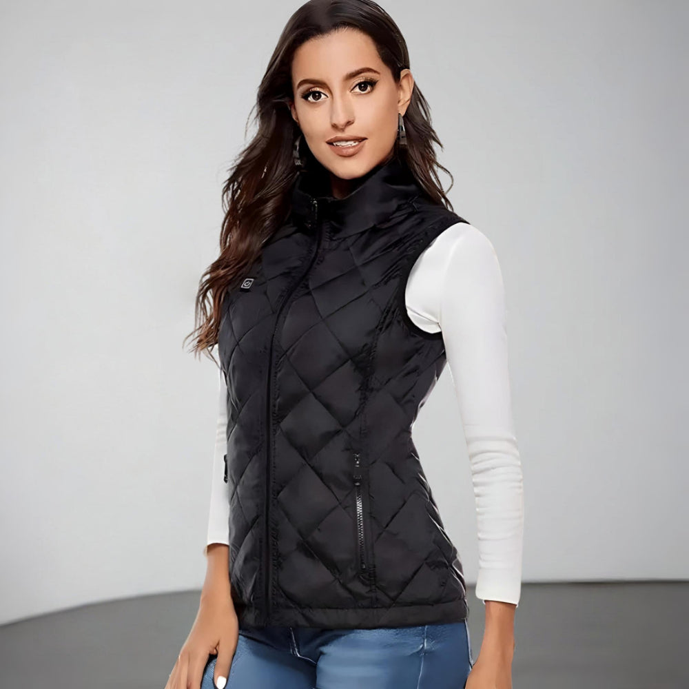 Woman wearing a heated vest, enjoying comfortable electric warmth during a snowy outdoor winter adventure.